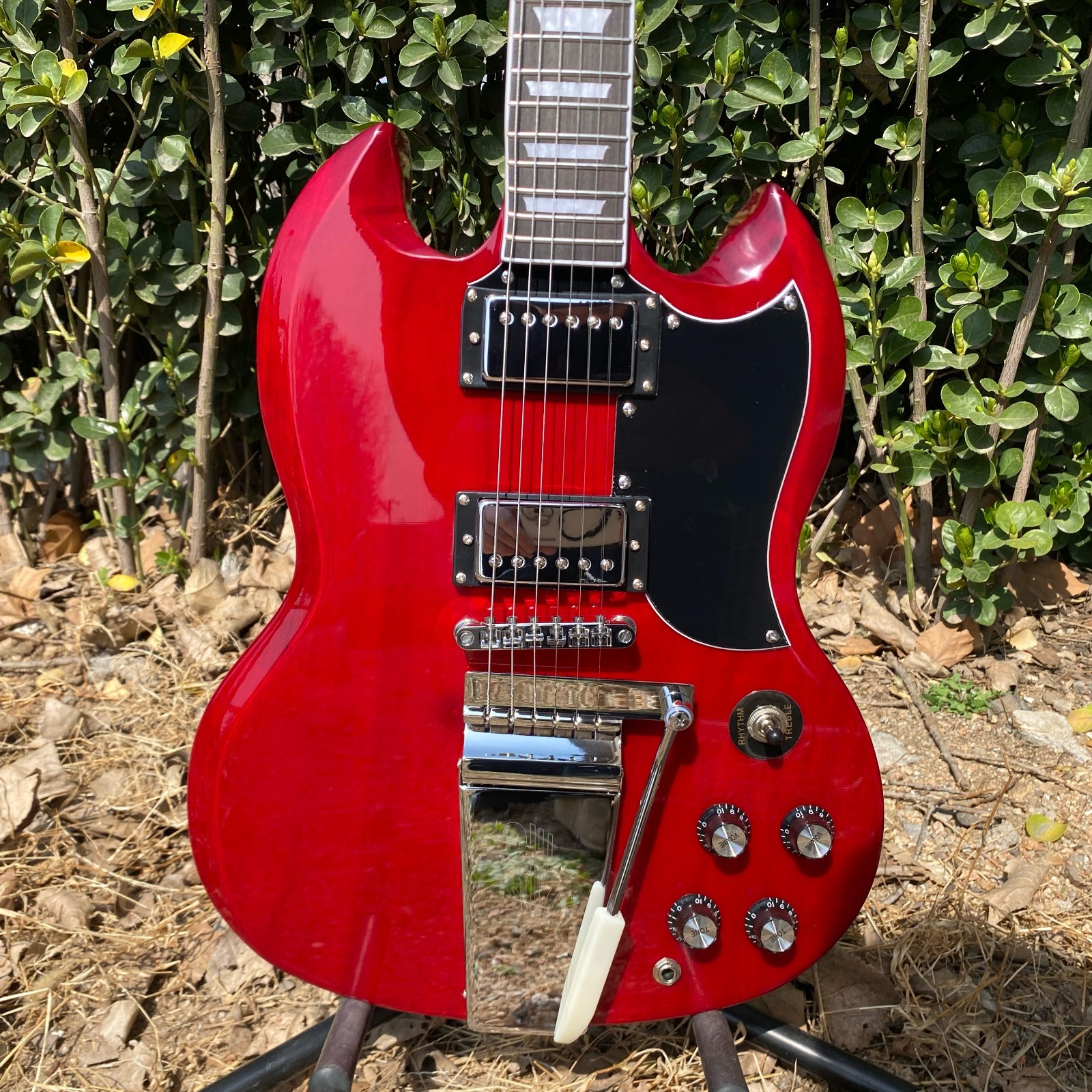 Brand-new, red 6-string electric guitar with mahogany body and chrome hardware.