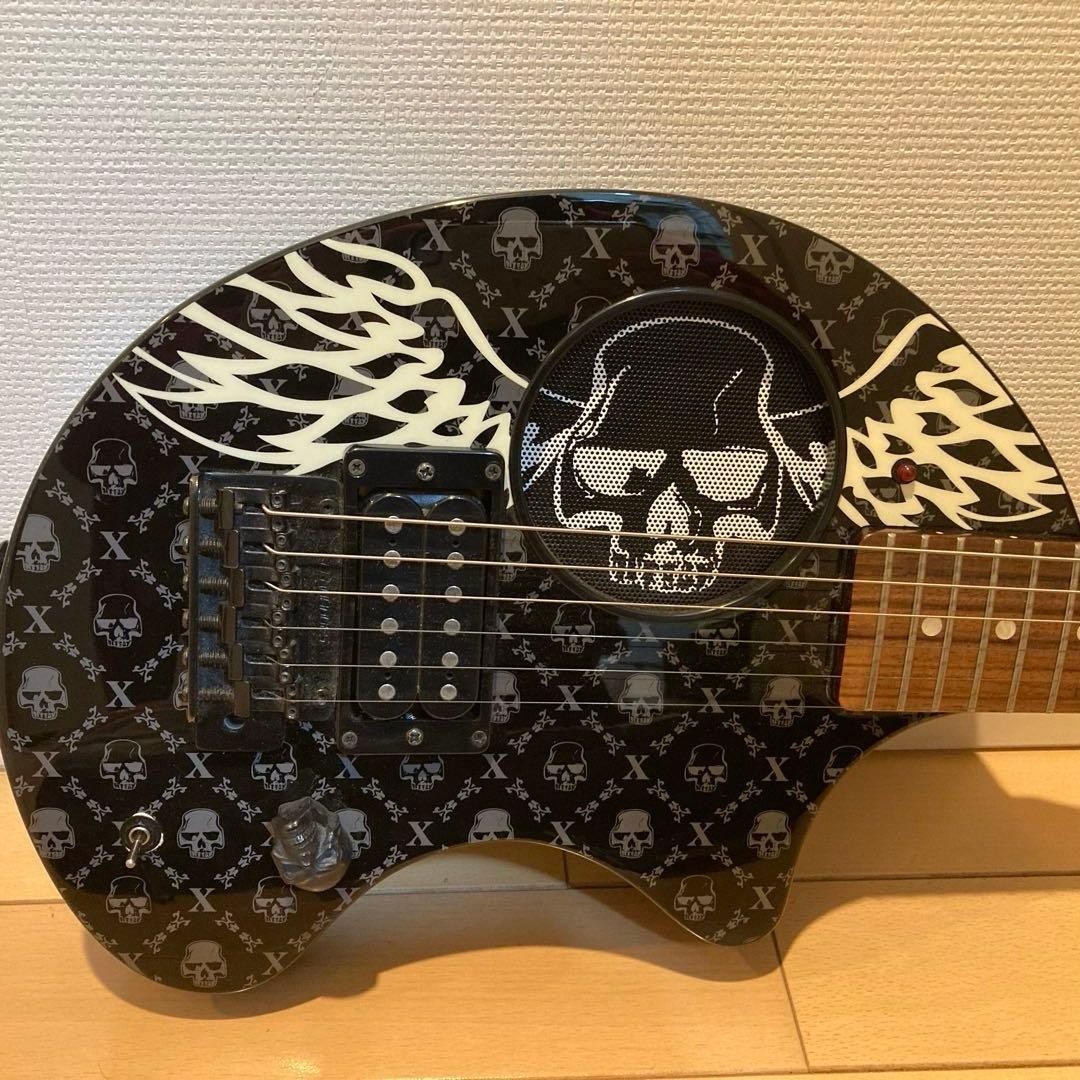Mint condition FERNANDES electric guitar with skull design, includes original ca