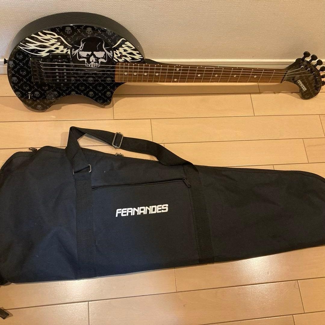 Mint condition FERNANDES electric guitar with skull design, includes original ca
