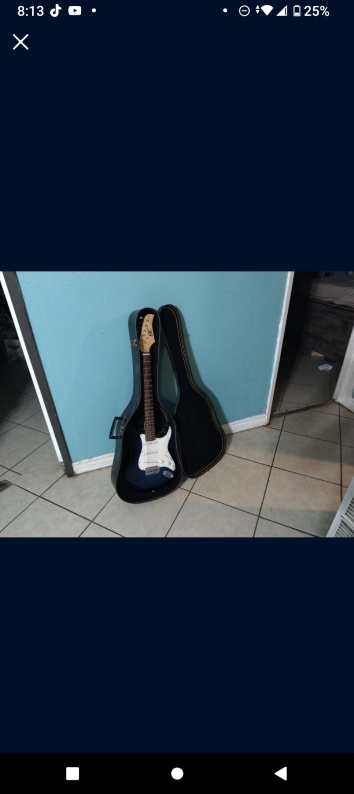 A Electric Guitar And A Black And Blue Color In Good Condition Comes With Case.