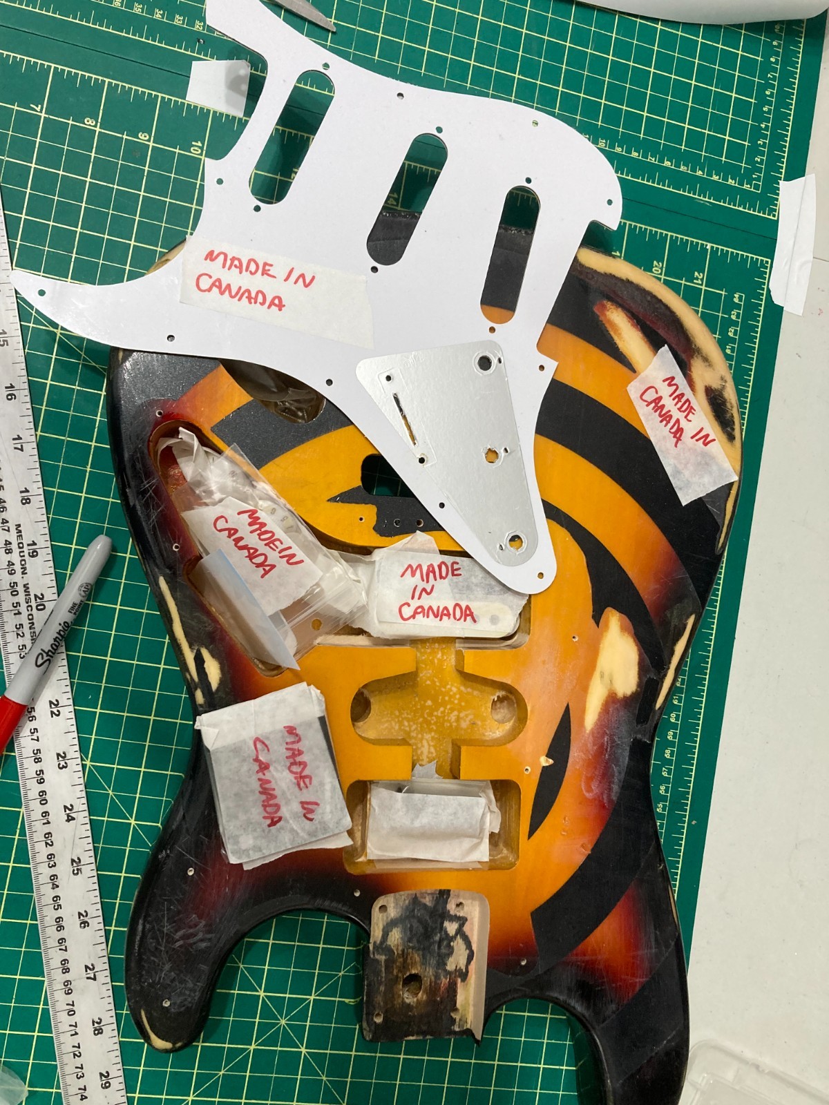 Relicd strat style guitar body, sunburst finish with bullseye graphic.