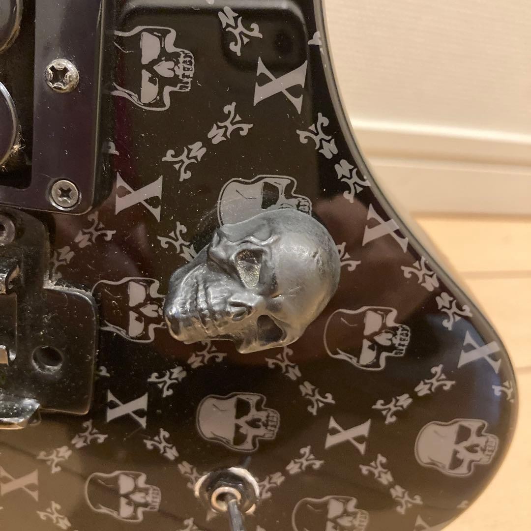 Mint condition FERNANDES electric guitar with skull design, includes original ca
