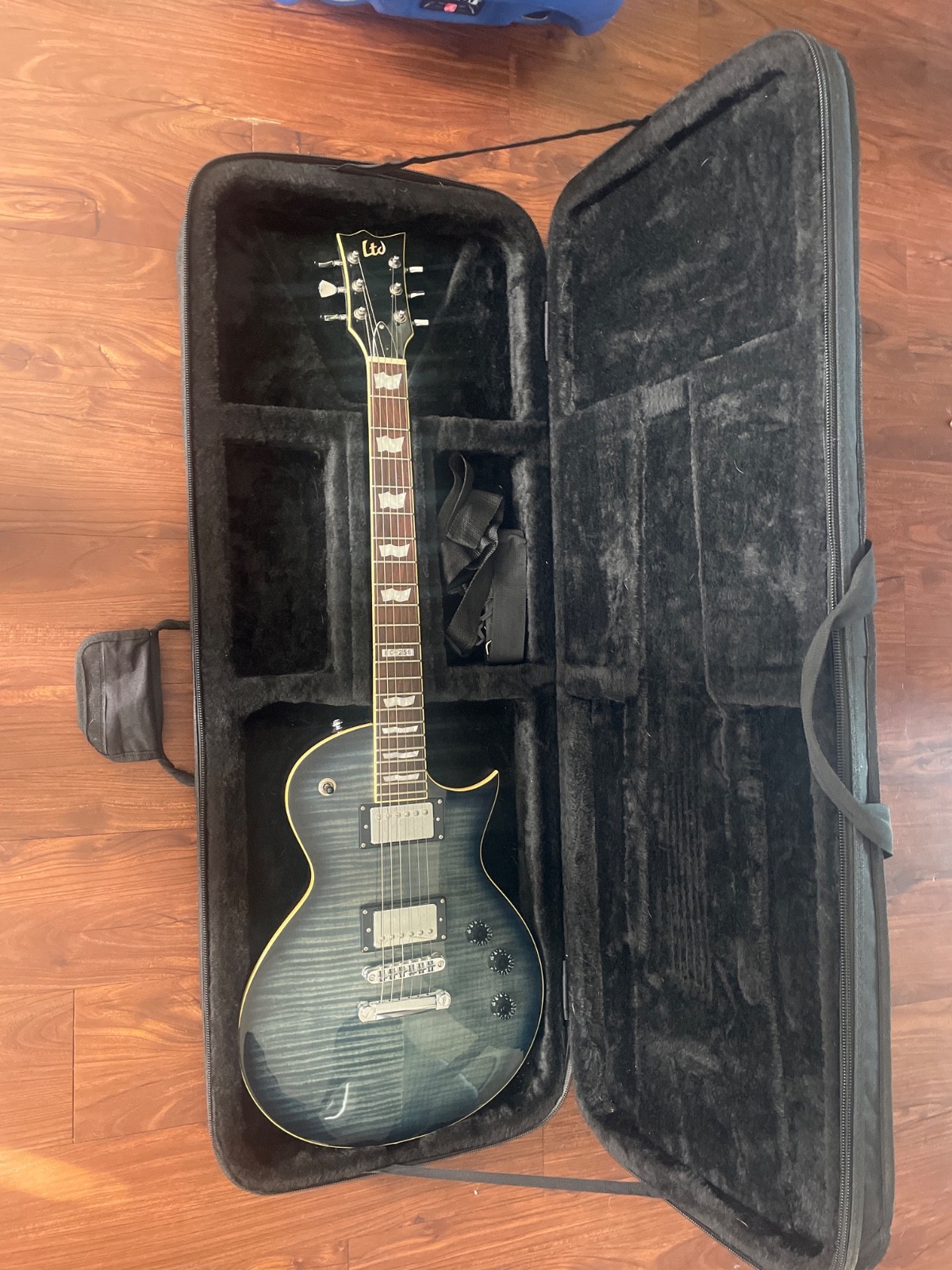 See through blue electric Les Paul guitar with case