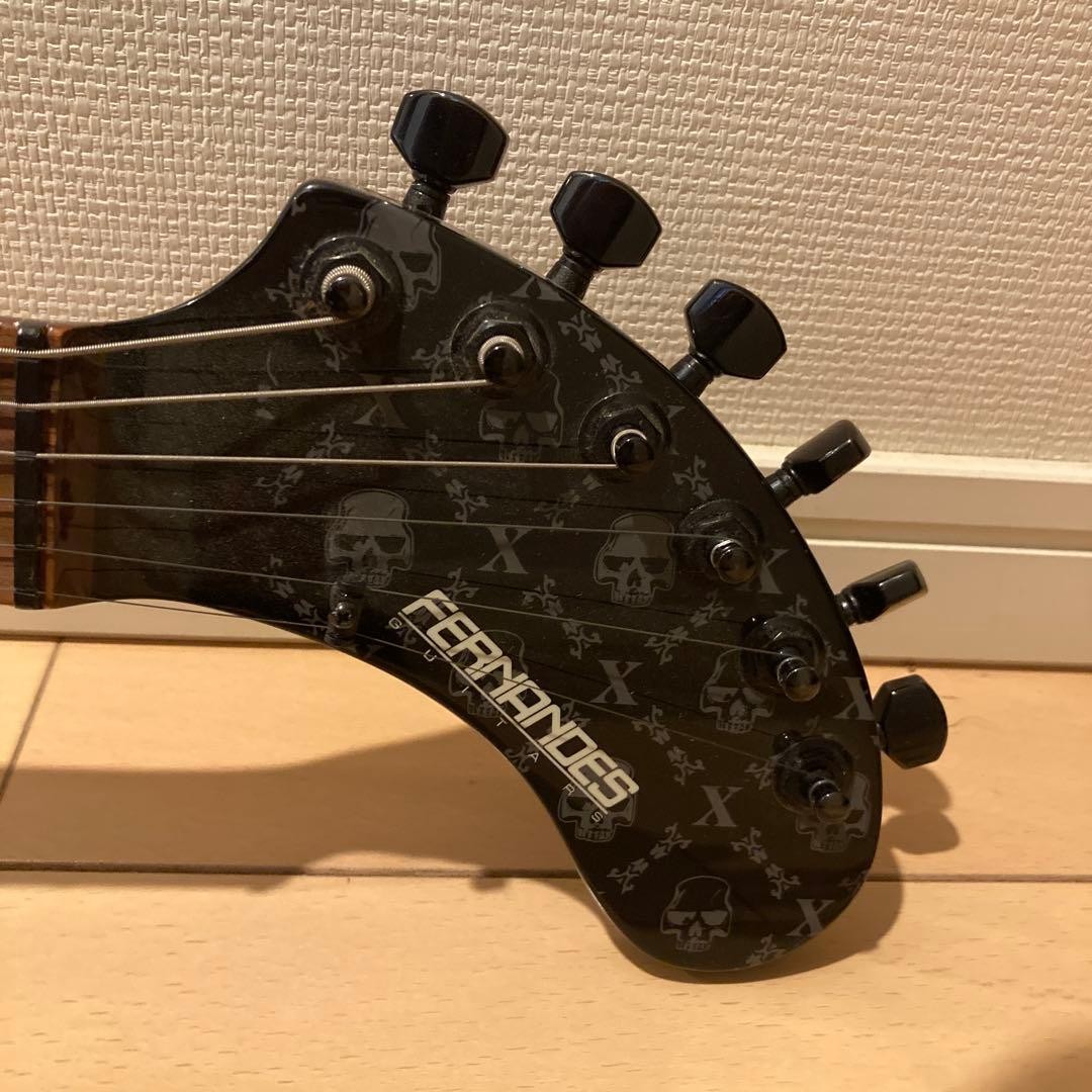 Mint condition FERNANDES electric guitar with skull design, includes original ca