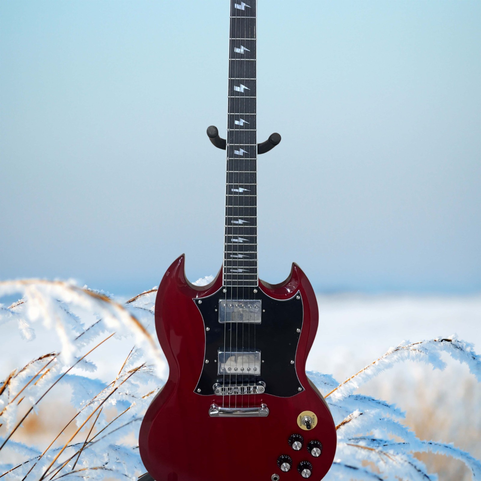 Burgundy electric guitar with a black pickguard and lightning-shaped inlays