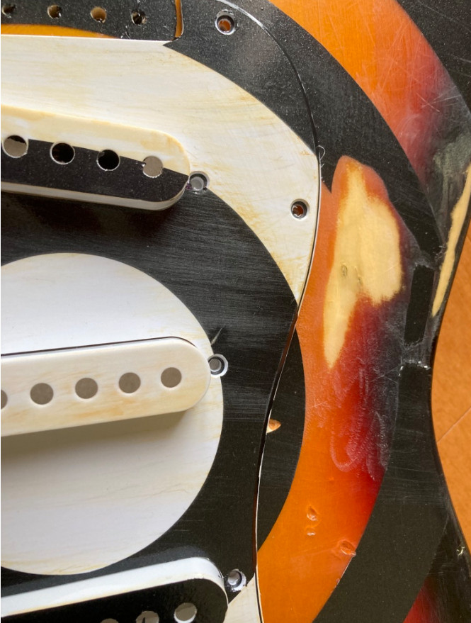 Relicd strat style guitar body, sunburst finish with bullseye graphic.
